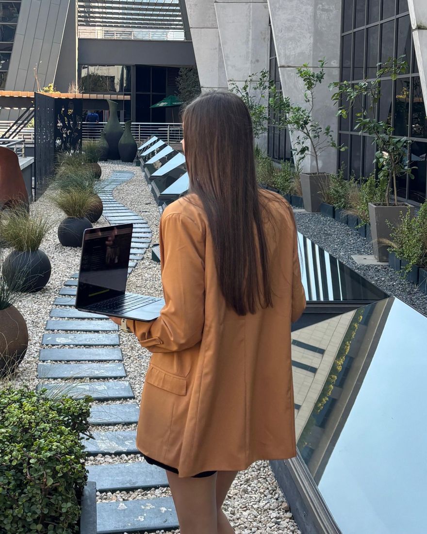 Vee van der Merwe walking with her laptop